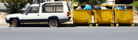 Truck pulling bins of trash