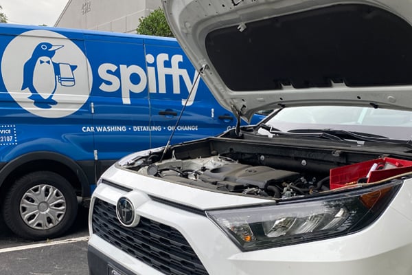 Spiffy van in the background as car is prepped for an oil change service