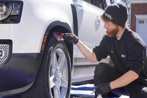attention to detail is key, A spiffy tech applies tire shine during a Detail service