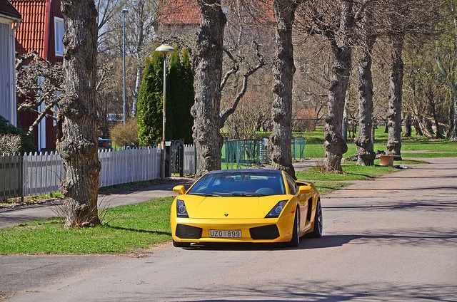 A Lamborghini luxury car driving on the street A Lamborghini luxury car driving on the street