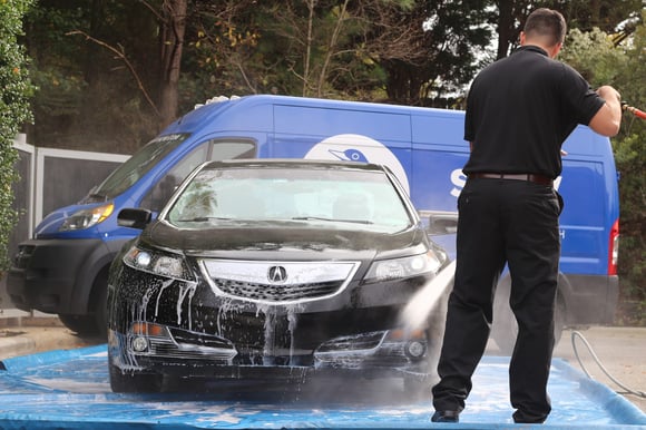 Spiffy technician car wash and detail for black Acura sedan