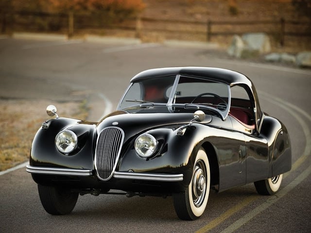 A beautiful vintage car hugging the road A beautiful vintage car hugging the road