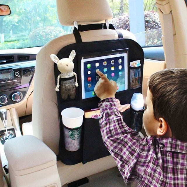 Child in carseat playing on Ipad in the car
