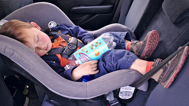 Baby sleeping peacefully in a car seat