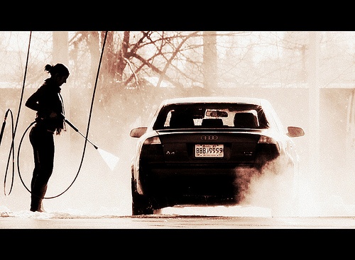 Dirty car getting a high pressure exterior wash Dirty car getting a high pressure exterior wash