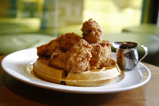 Fried chicken atop a golden brown waffle Fried chicken atop a golden brown waffle