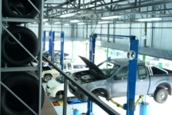 A automotive mechanic shop with vehicles on lifts getting ready to be serviced