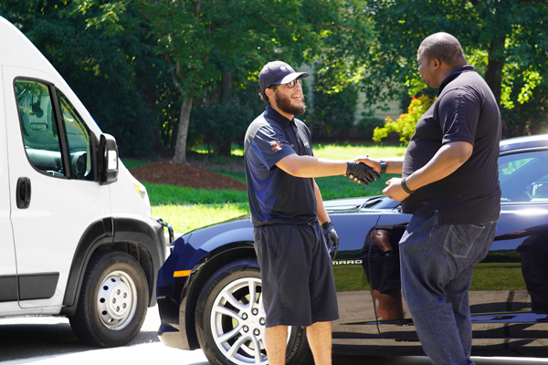 Mobile service technician shaking a customers hand