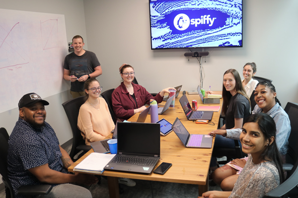 Co-workers gather in a conference room for their weekly meetings.