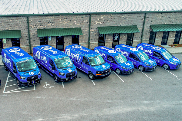 A fleet of Spiffy vans, showcasing the diversity of van upfits.
